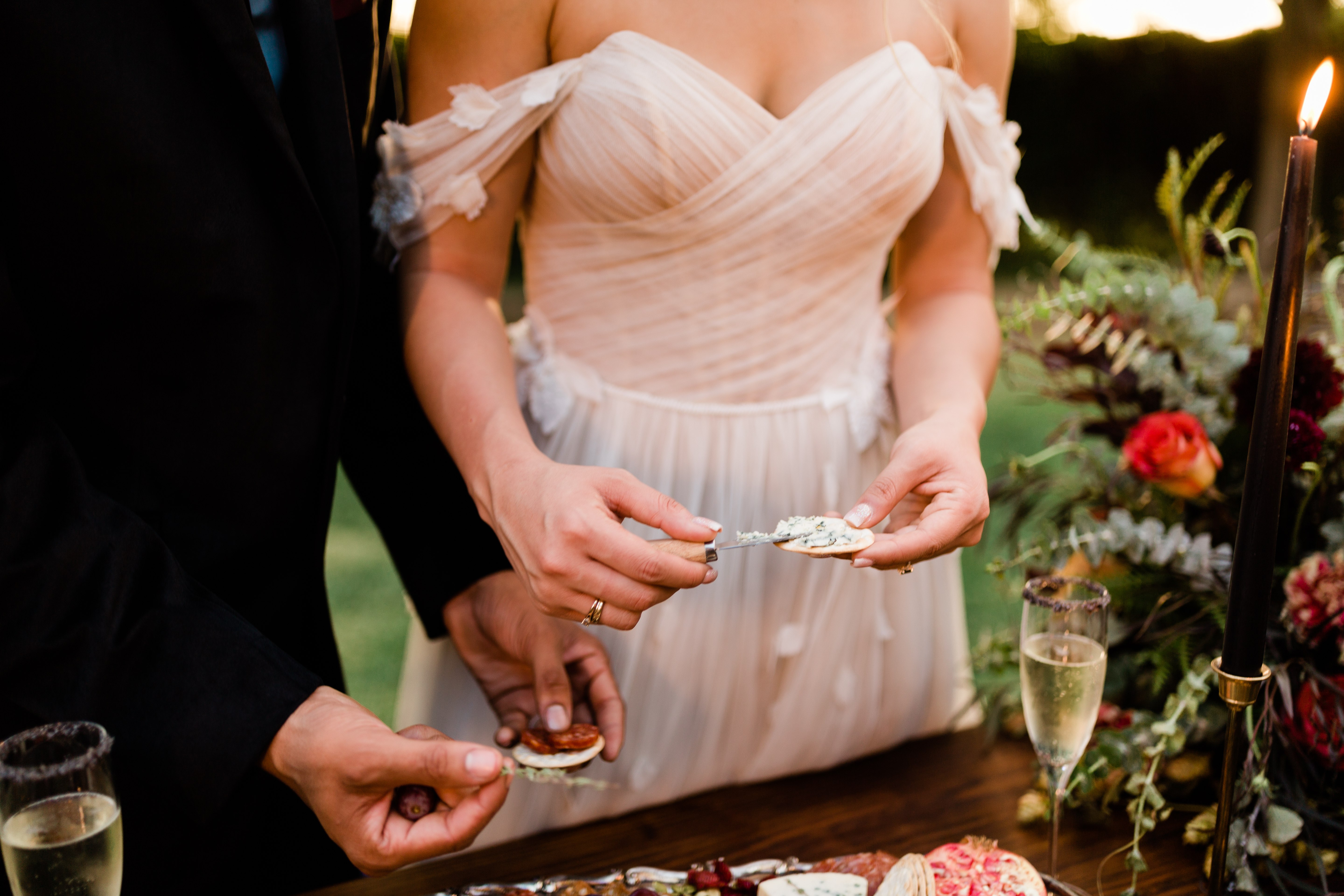 bride and groom eating charcuterie