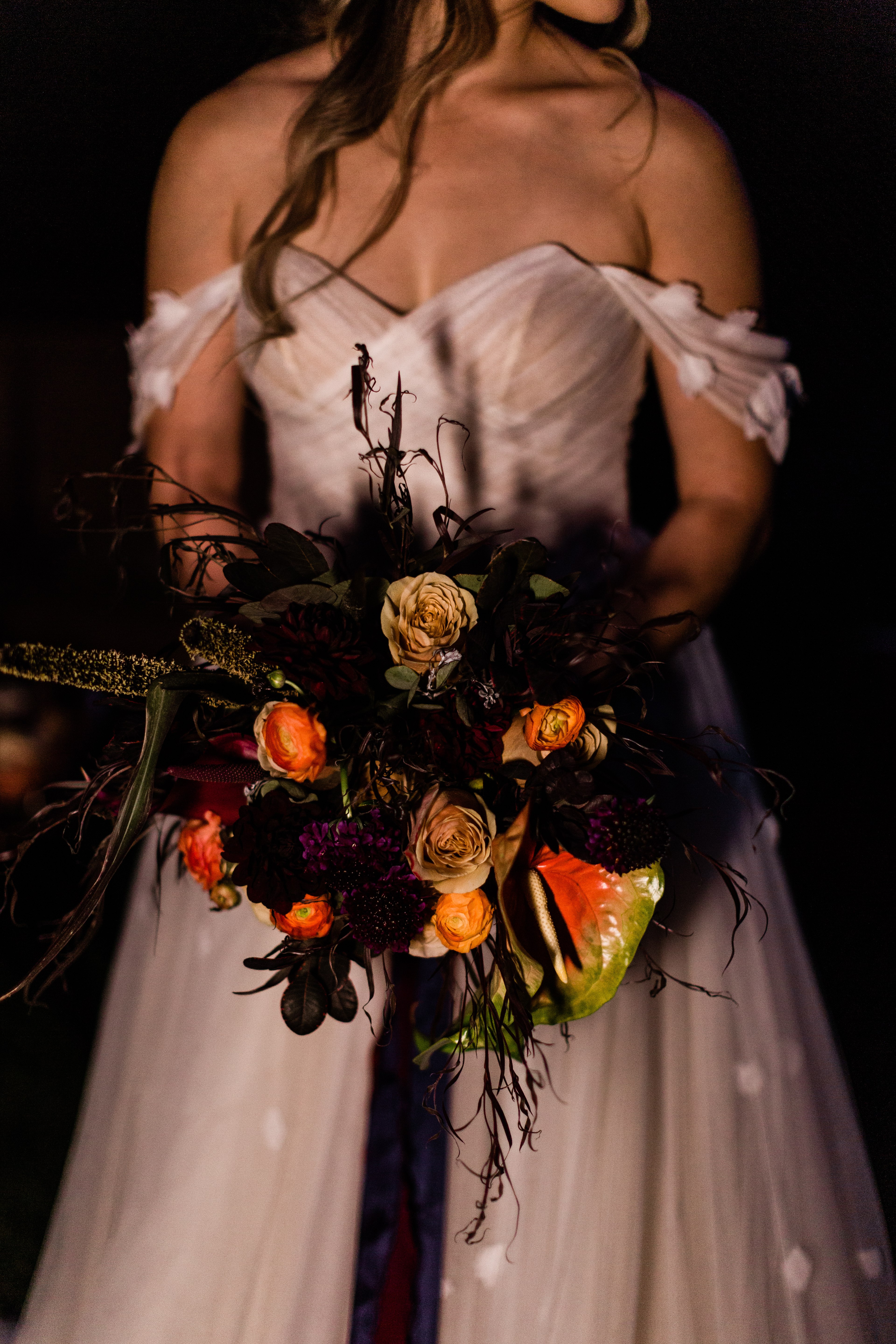 halloween wedding portraits of a bride and her dark wedding bouquet