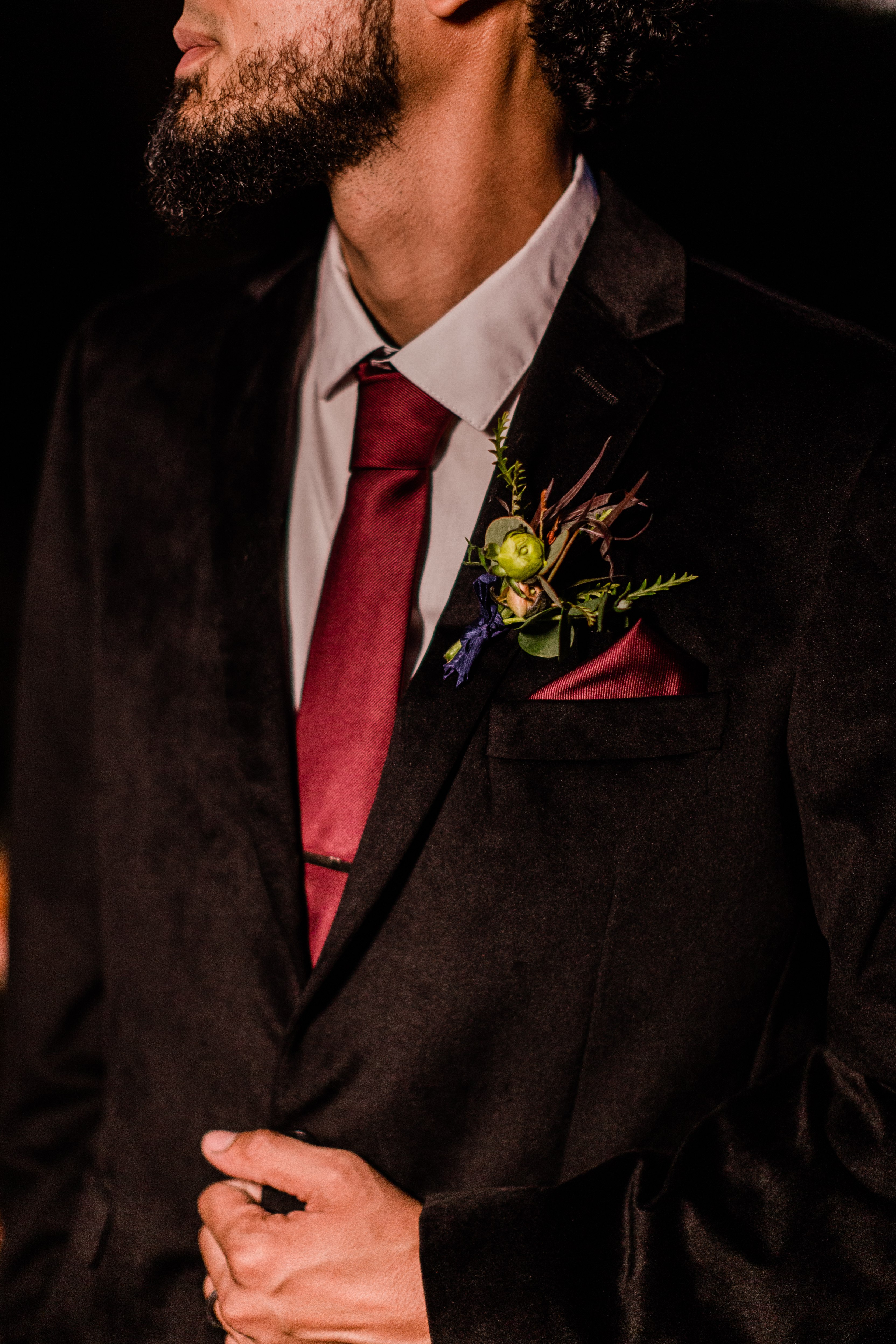 halloween wedding portraits of the groom in a black velvet suit
