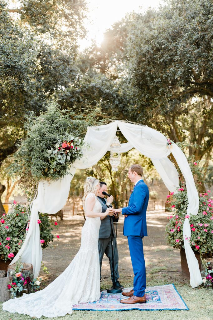 outdoor ceremony with draped arch