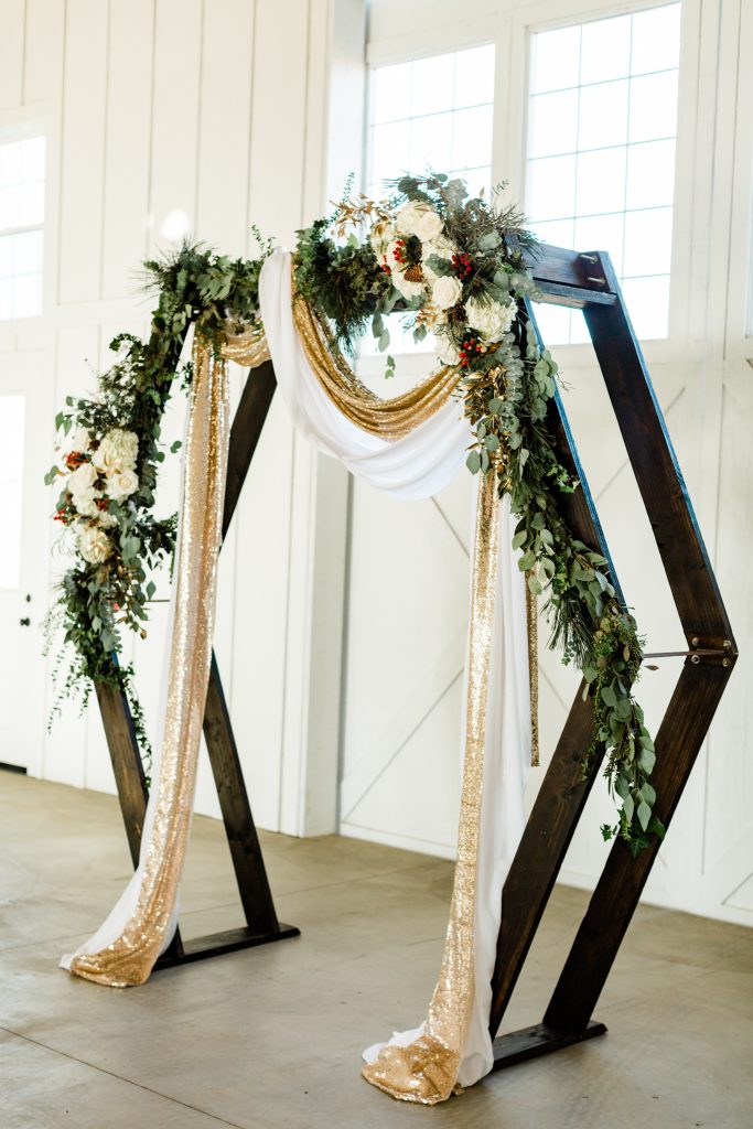 Geometric arbor set up for a Christmas wedding ceremony