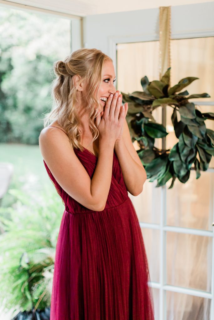 woman happily smiling before her surprise proposal