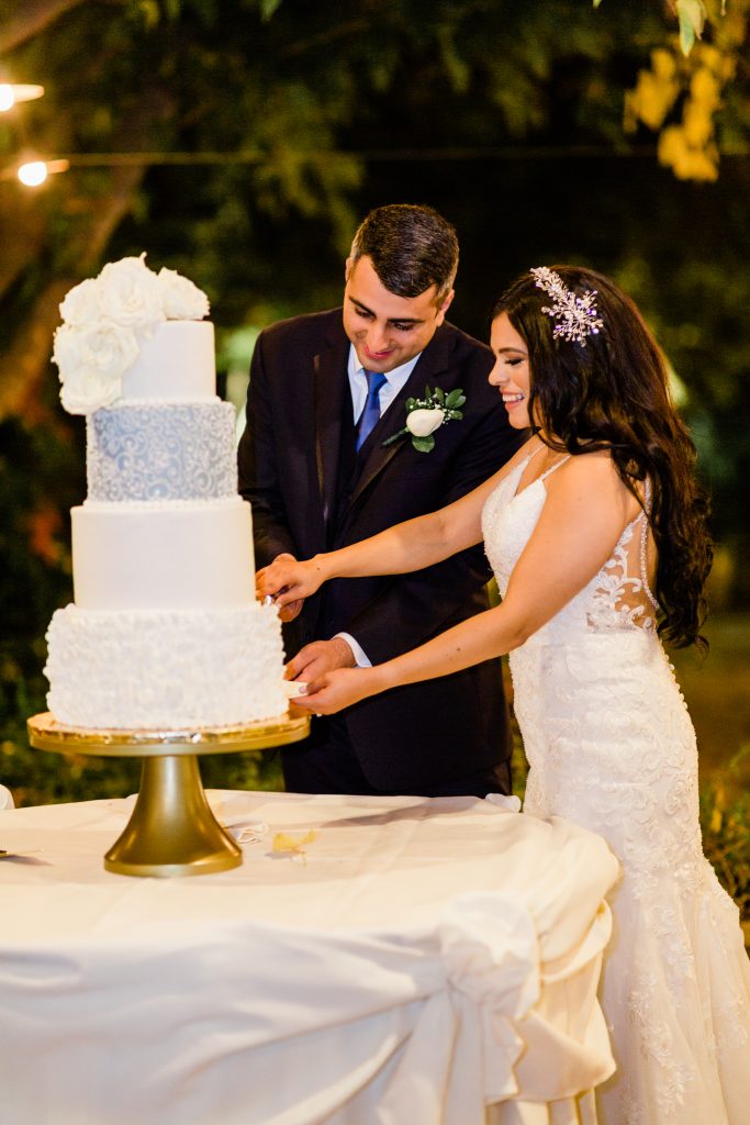 4 tier white wedding cake and cake cutting ceremony