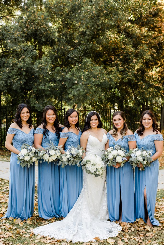 blue bridesmaid dresses with white bouquets
