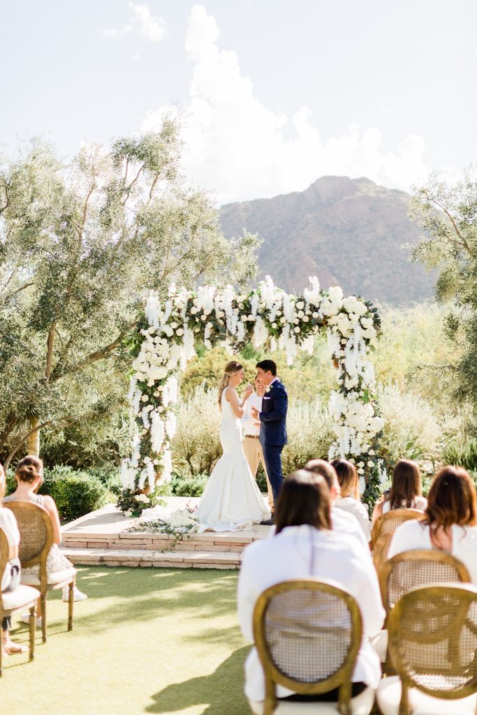 outdoor ceremony with natural green and white near mountains
