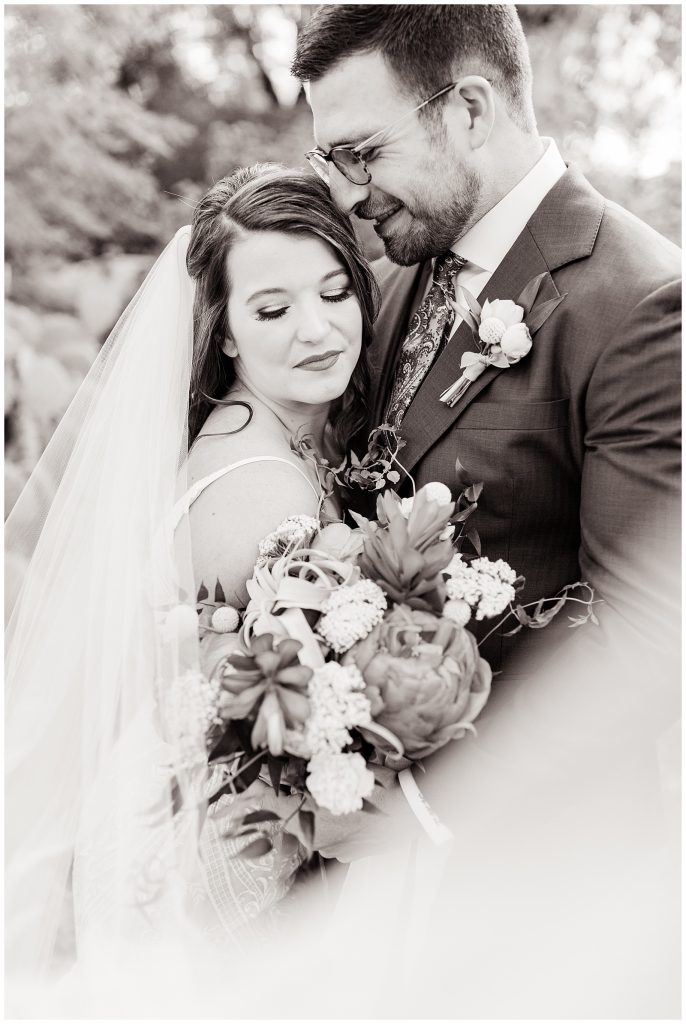 black and white picture of bridal couple with bouquet