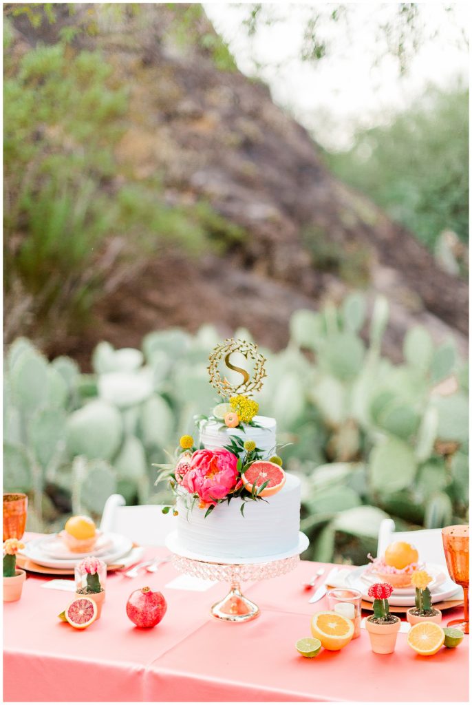 head table with 2 tier cake and citrus decor