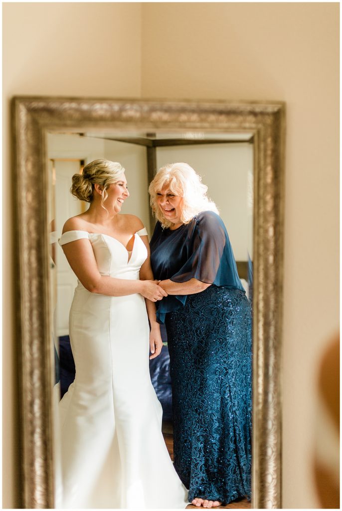 bride and mom sharing a candid laugh while getting ready
