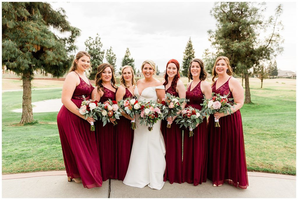 Red bridesmaids with pink and white bouquets at Copper River Country Club