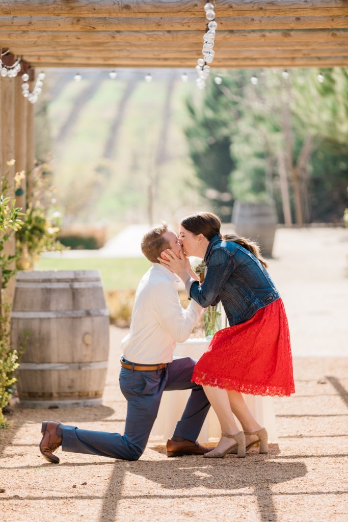 woman kissing her new fiance after he proposed