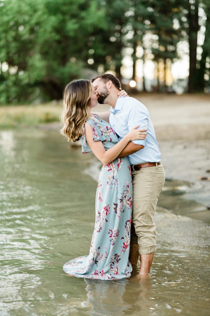 engaged couple kissing along the shores of shaver lake in california
