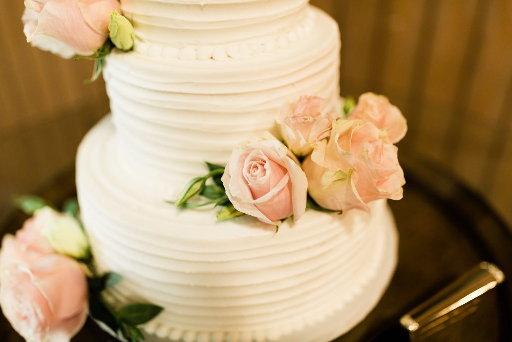 3 tier white wedding cake with pink roses