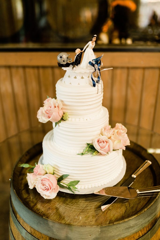 3 tier wedding cake with funny cowboys topper