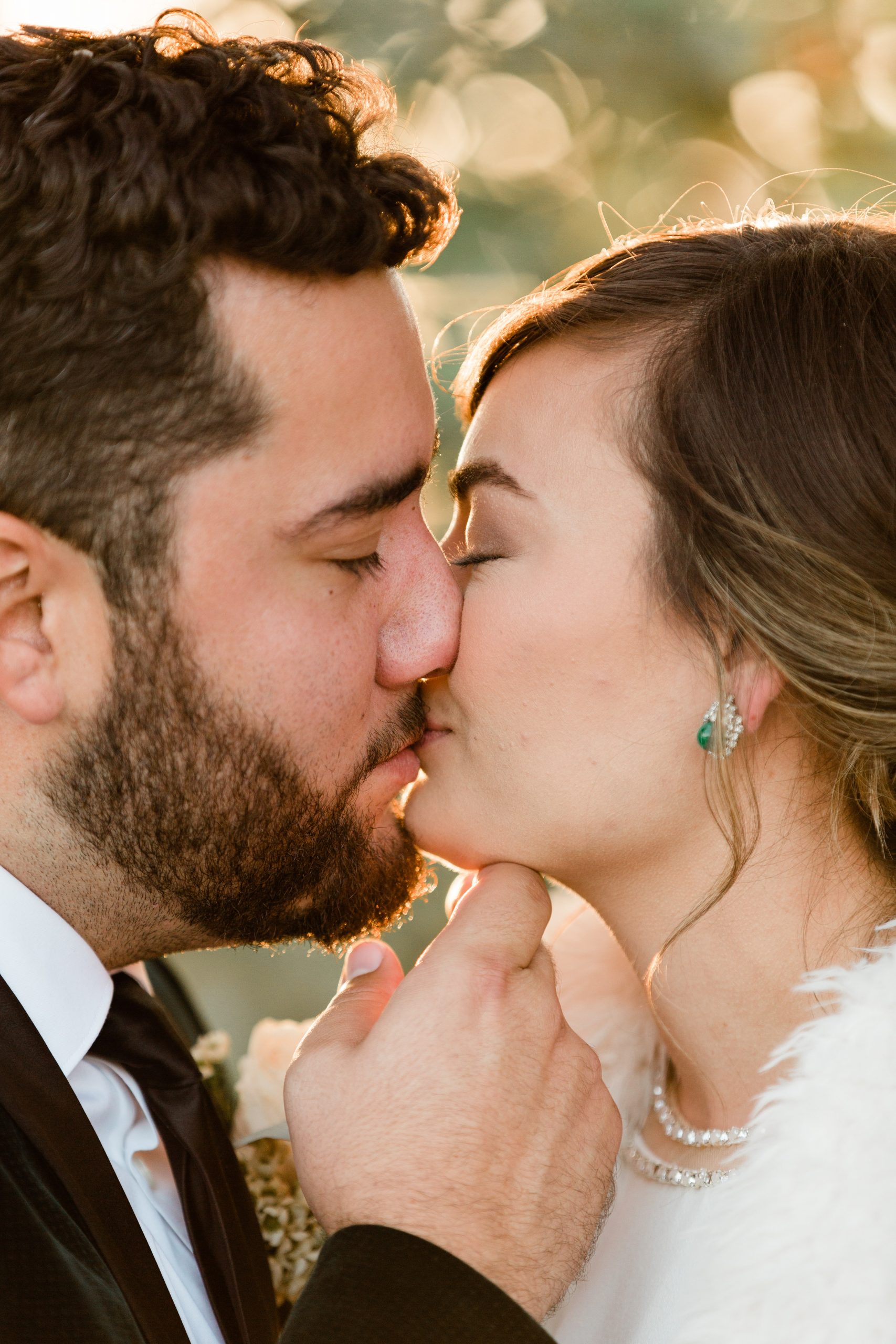 close up bride and groom sunset wedding kiss