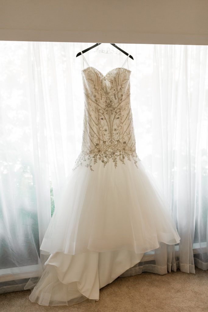 justin alexander wedding dress with a beaded bodice and tulle skirt with a train