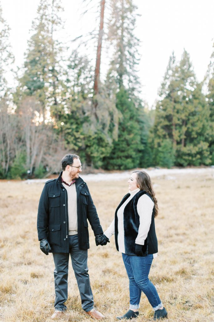 couple bundled up for a winter engagement session in shaver lake california
