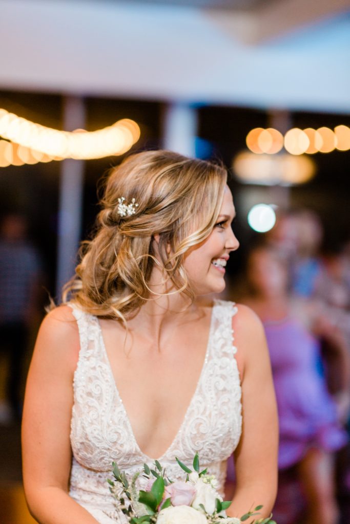 Bride smiling and looking to the side in a beaded dress