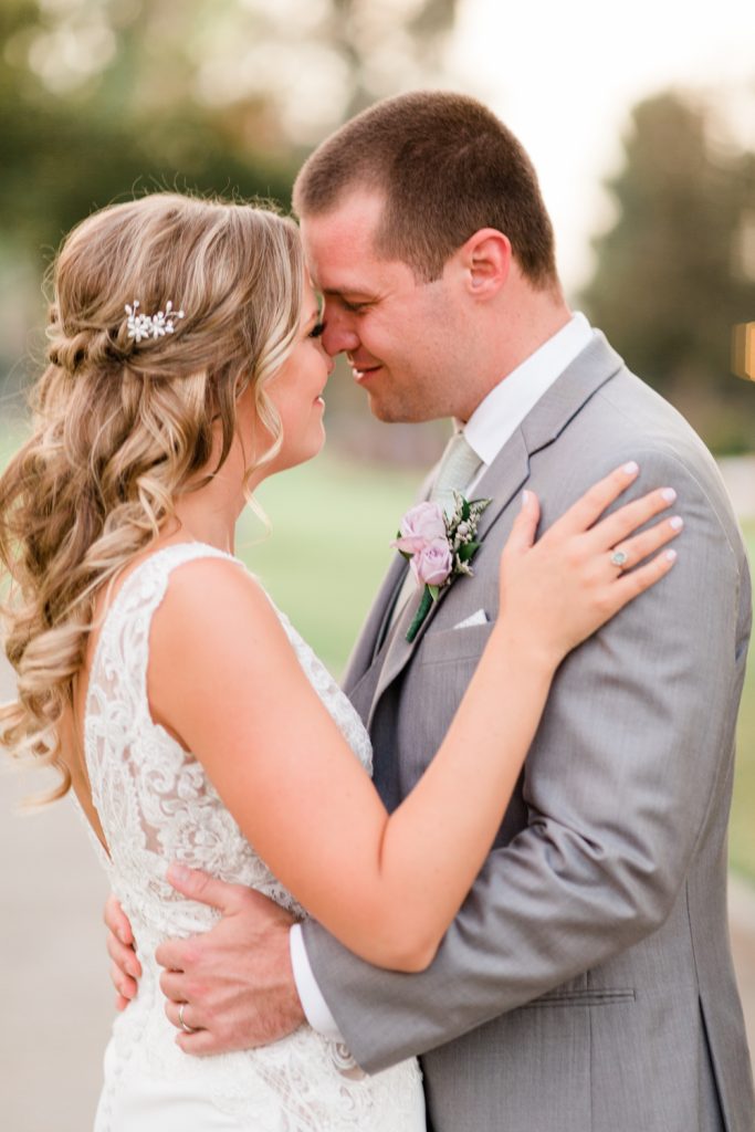Couple forehead to forehead in love at their country club wedding