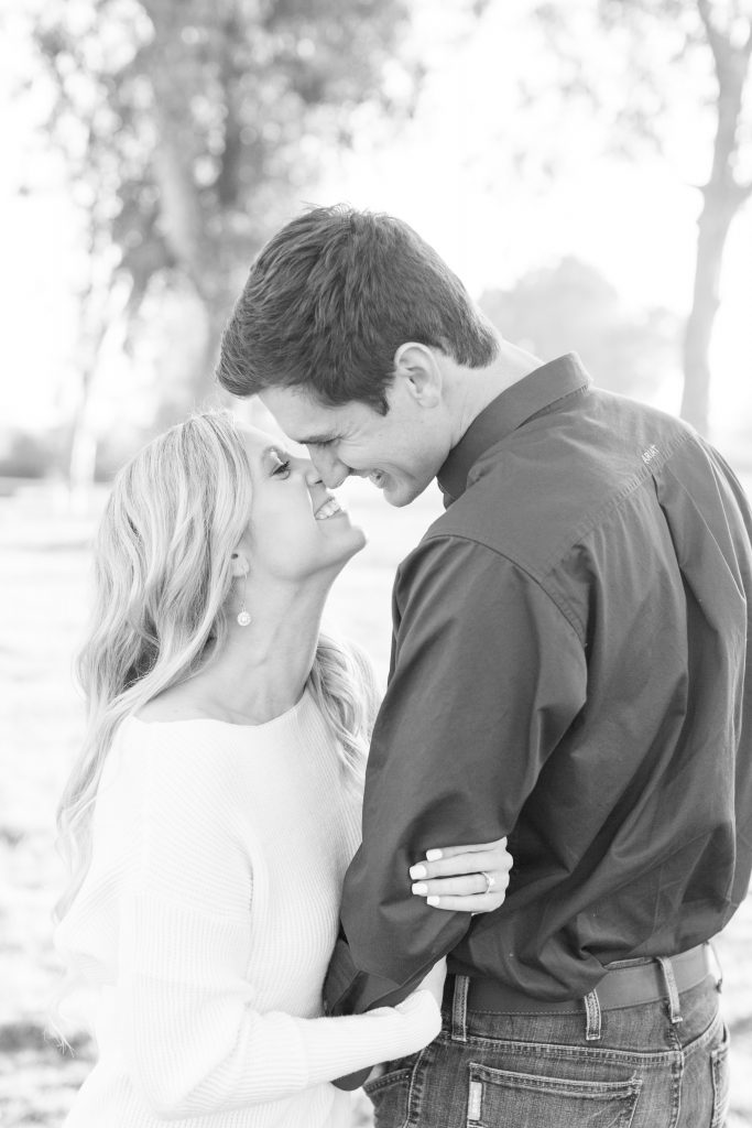 couple leaning in to each other in black and white 