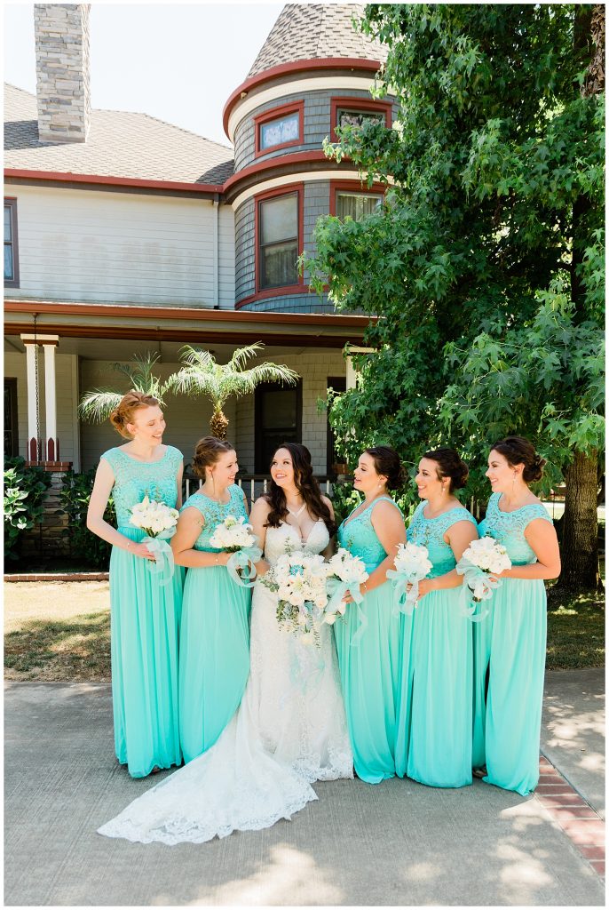 Bridesmaids standing together talking candidly