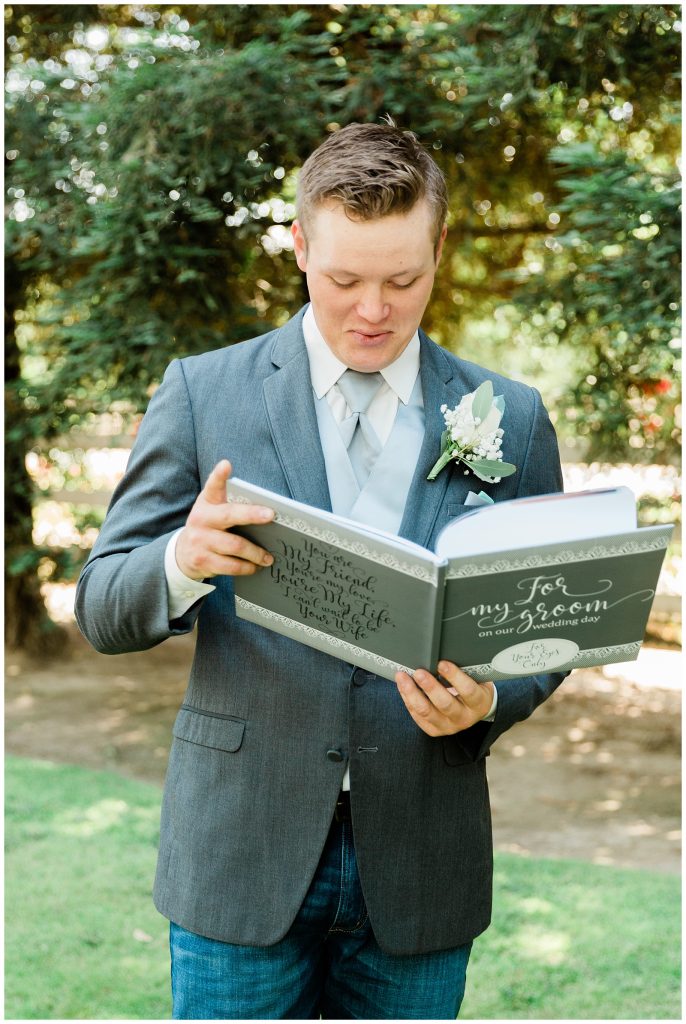 Groom looking at book gifted to him. 