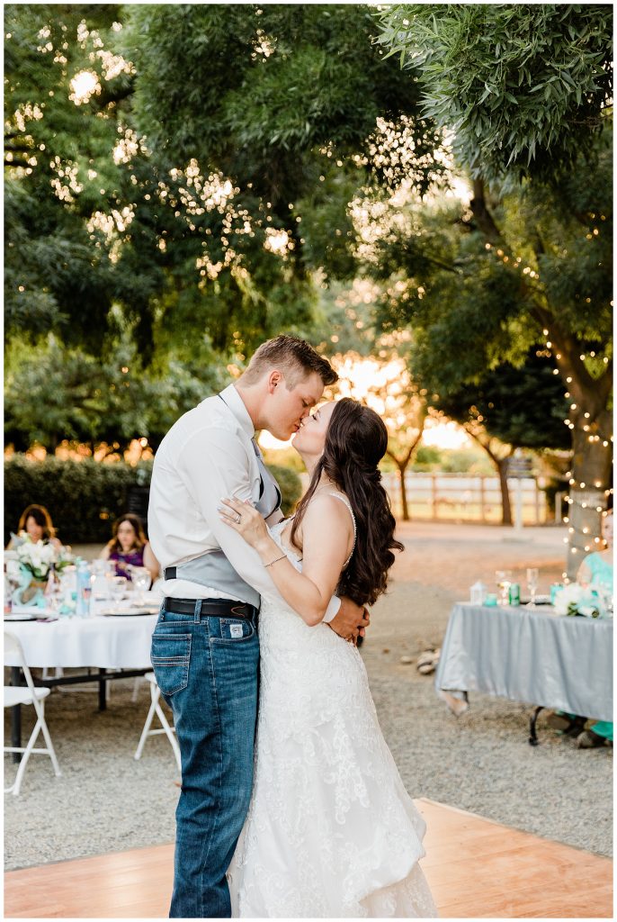 Couple kissing while enjoying their first dance at Whitney's Wild Oak Ranch.