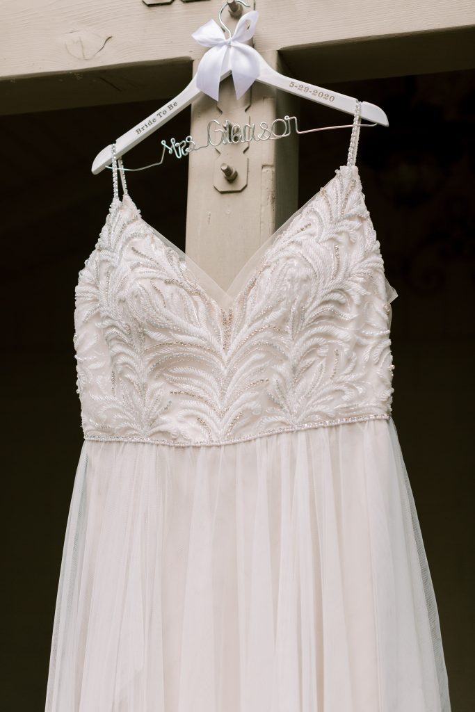 Beaded and chiffon Maggie Sottero wedding dress on custom hanger