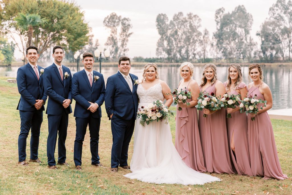 Groomsmen in navy and bridesmaids in blush for a fall wedding