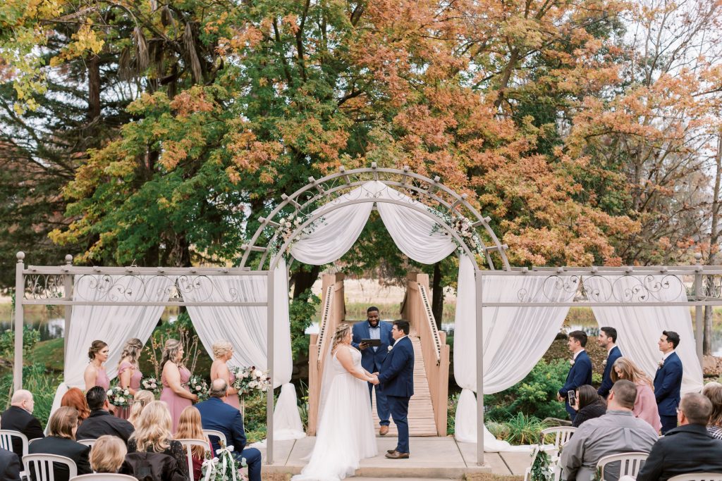 Full view of outdoor fall wedding ceremony at Wolf Lake Park.