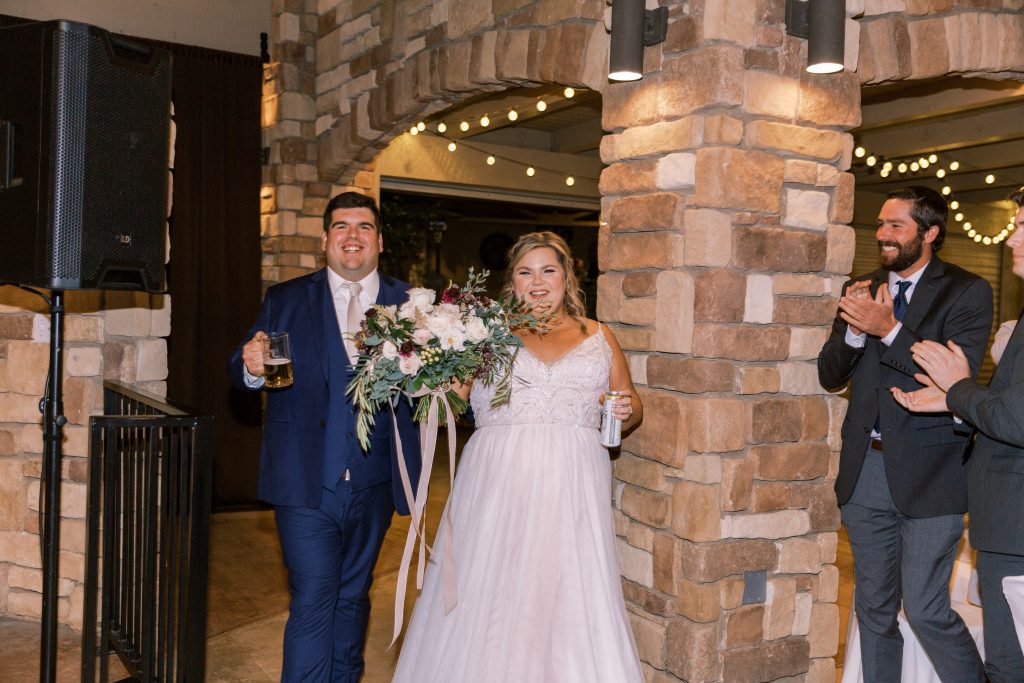Newlyweds entering reception ready to party