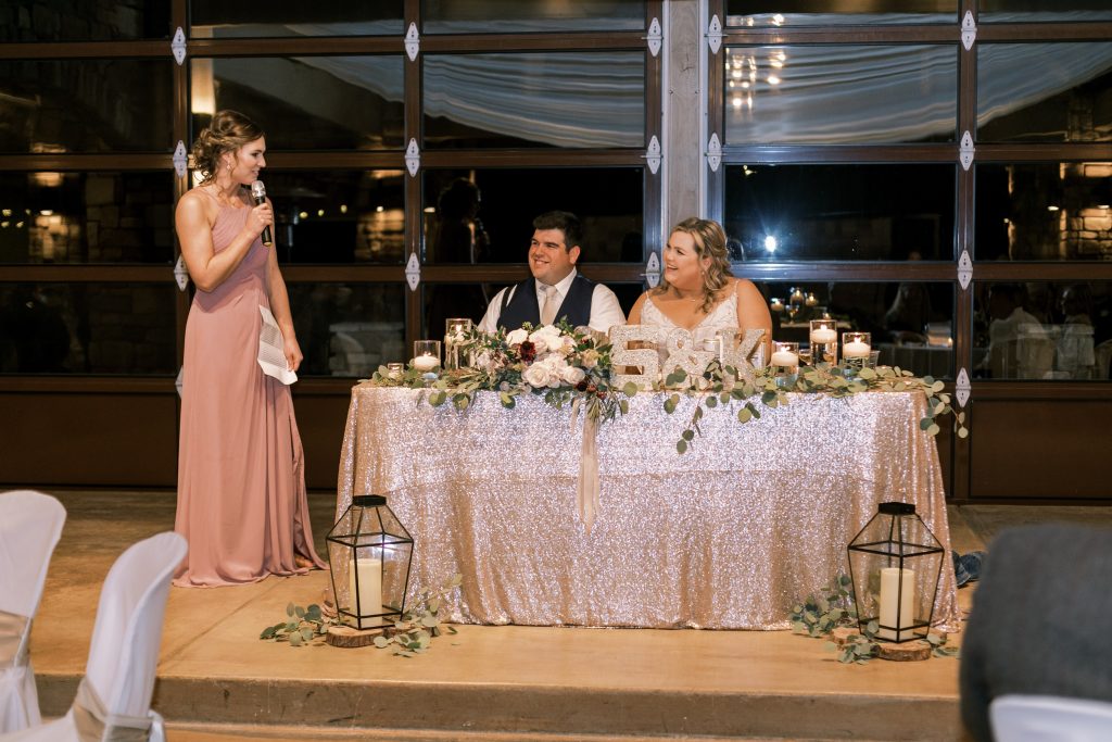 Bridesmaid in blush giving her speech