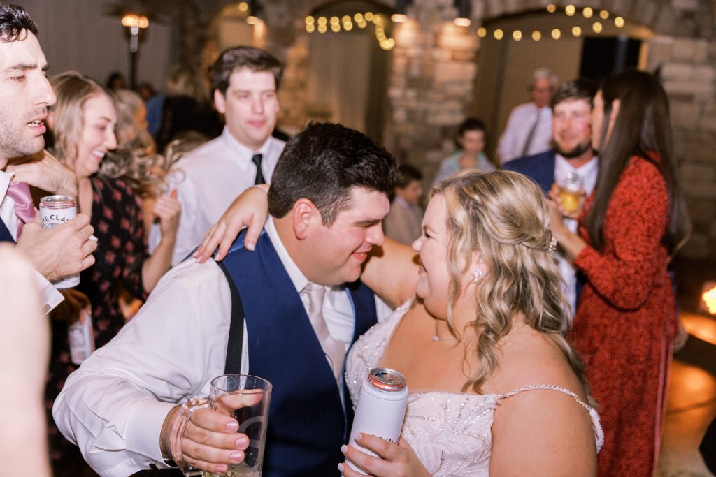 Bride and groom enjoying a drink and each other during reception