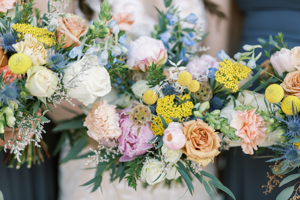 Colorful bouquets with pink, yellow, blue, peach florals. 
