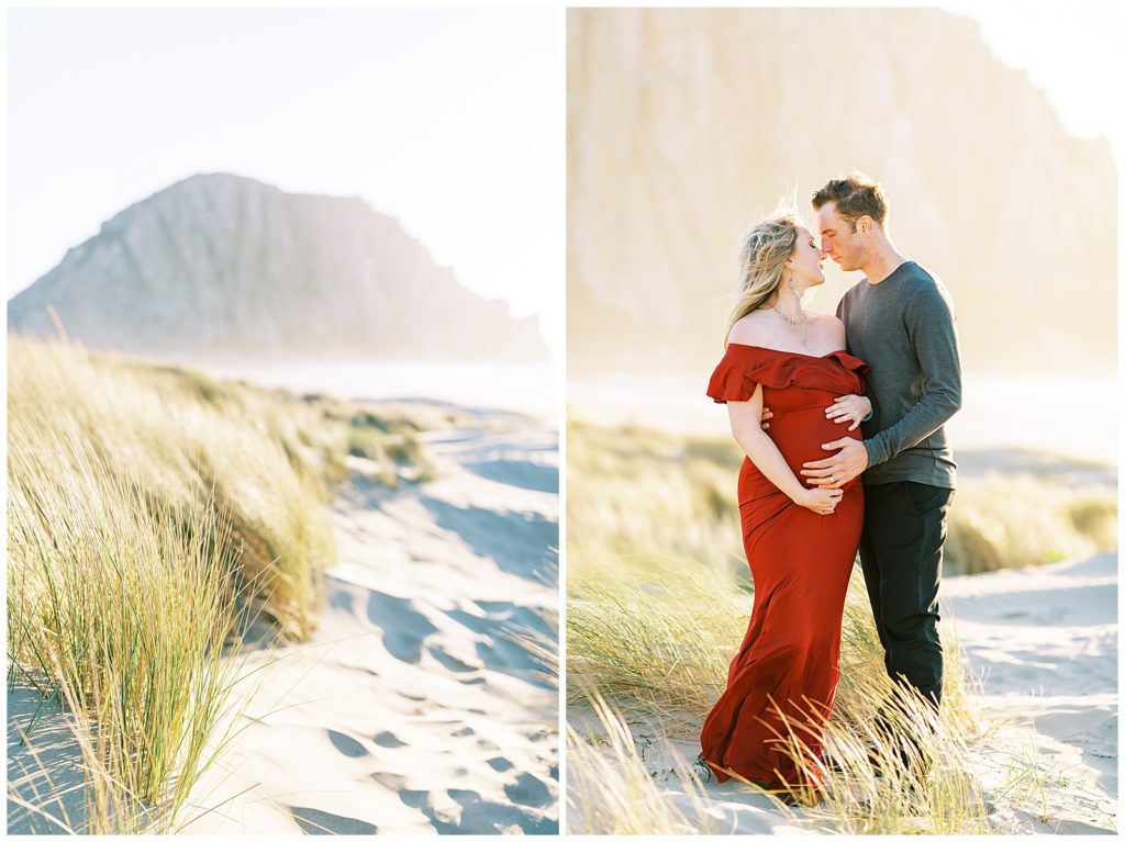 Maternity couple in the sand and grass standing nose to nose