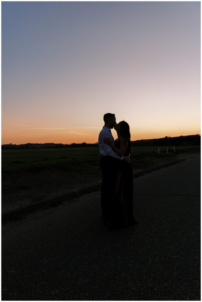 Couple silhouette kissing at sunset. 