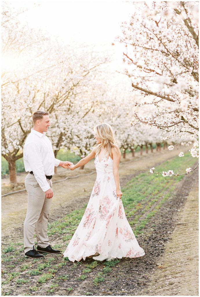 35mm film spring engagement photos in almond blossom orchard