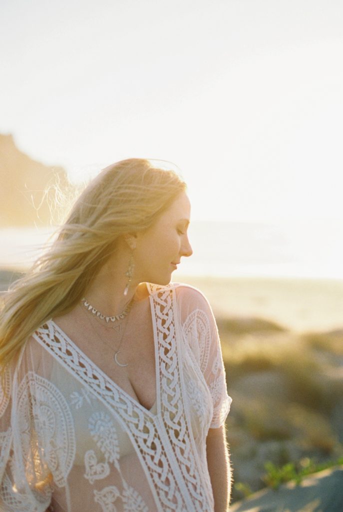 Film photo of woman during sunset at beach maternity photos