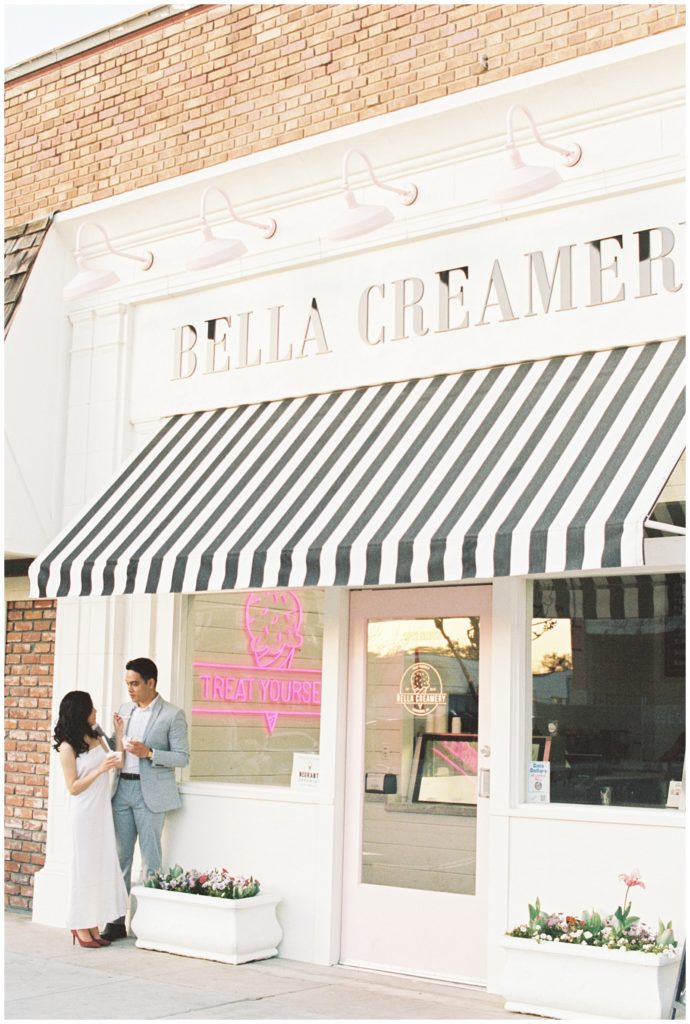 Couple feeding each other ice cream in downtown Kingsburg shot on 35mm film