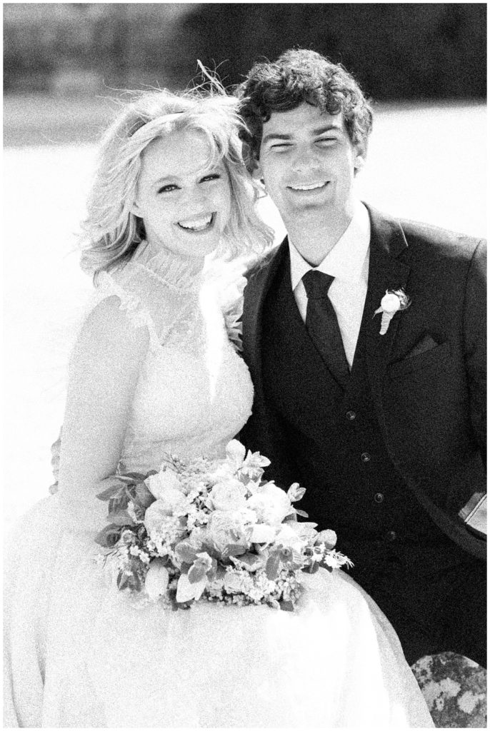 black and white grainy film photo of a bride and groom dressed in classic wedding attire at a sunstone winery wedding in santa ynez