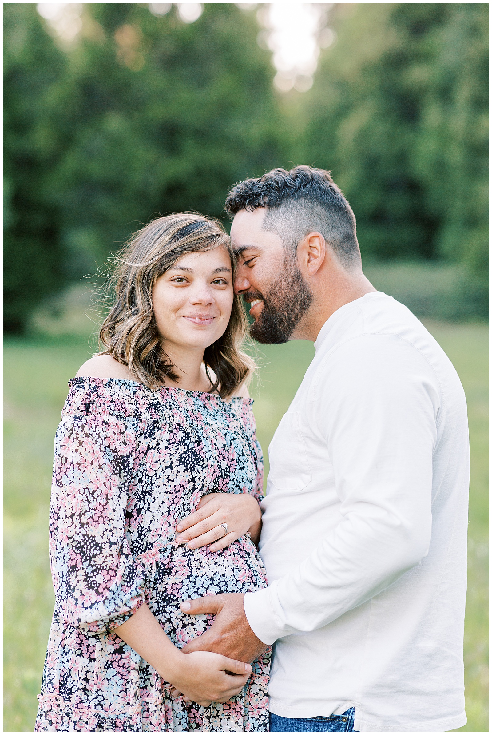 close up photo of husband and pregnant wife smiling