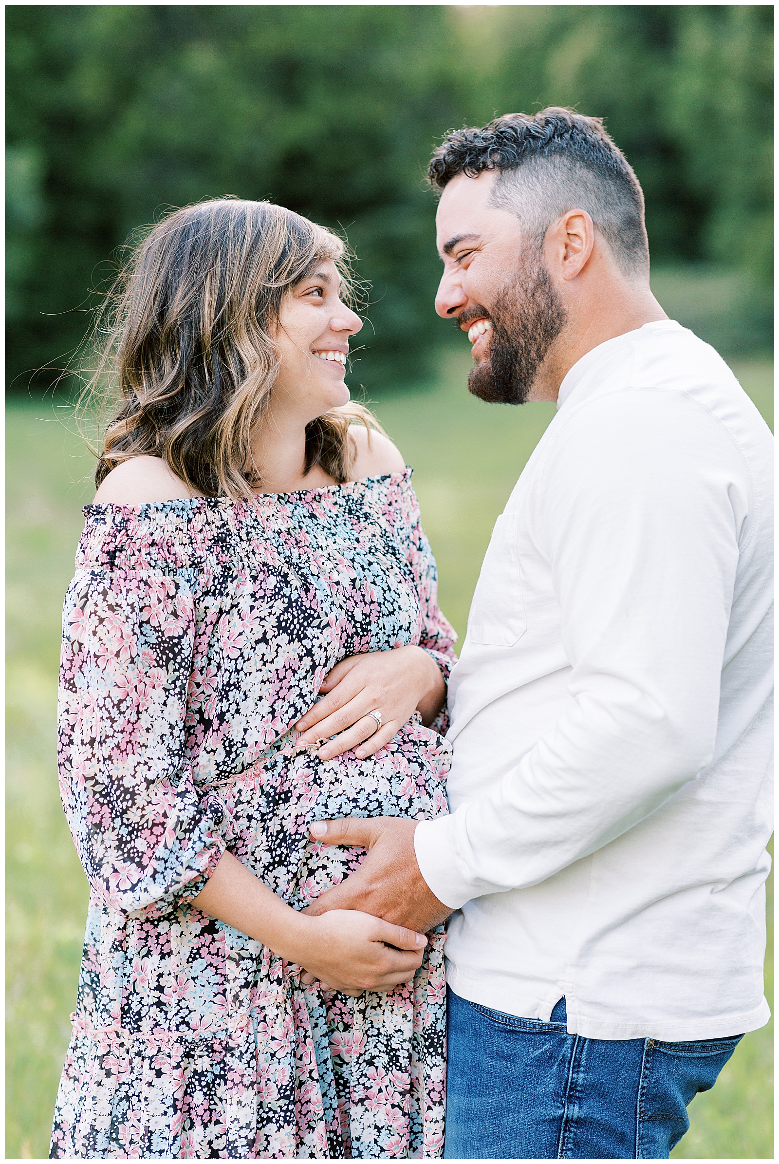 close up of pregnant couple looking at eachother and smiling