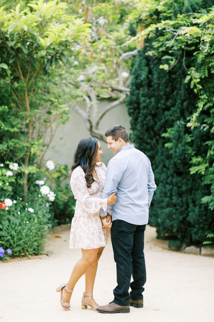 engaged couple embracing in Old Monterey Secret Gardens
