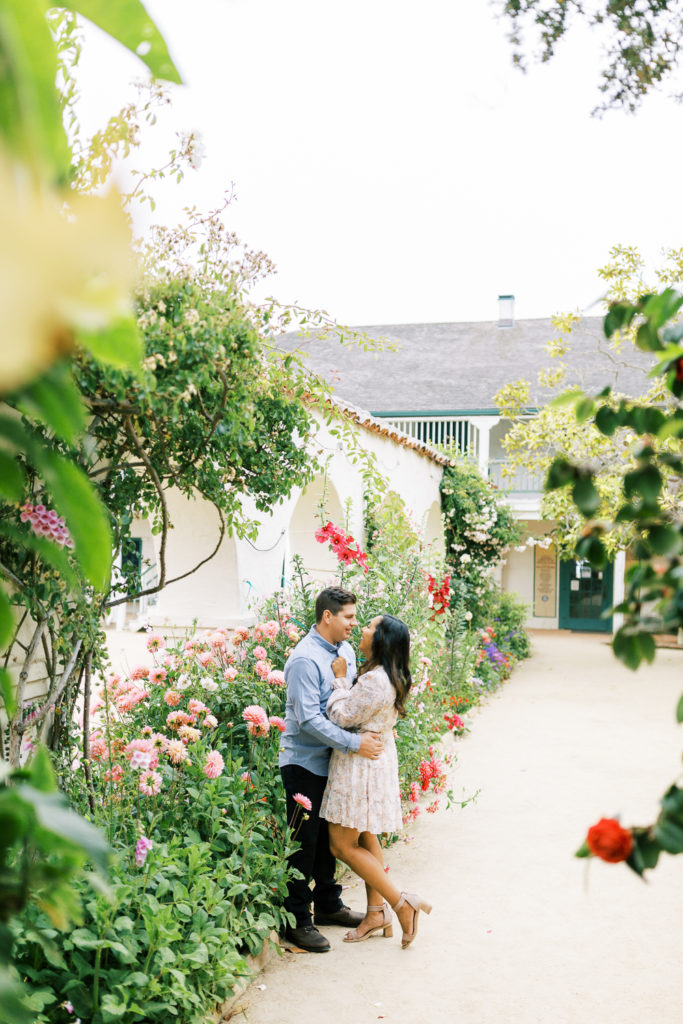 couple embracing in the middle of the secret gardens in old town Monterey by Fresno Wedding Photographer Megan Helm