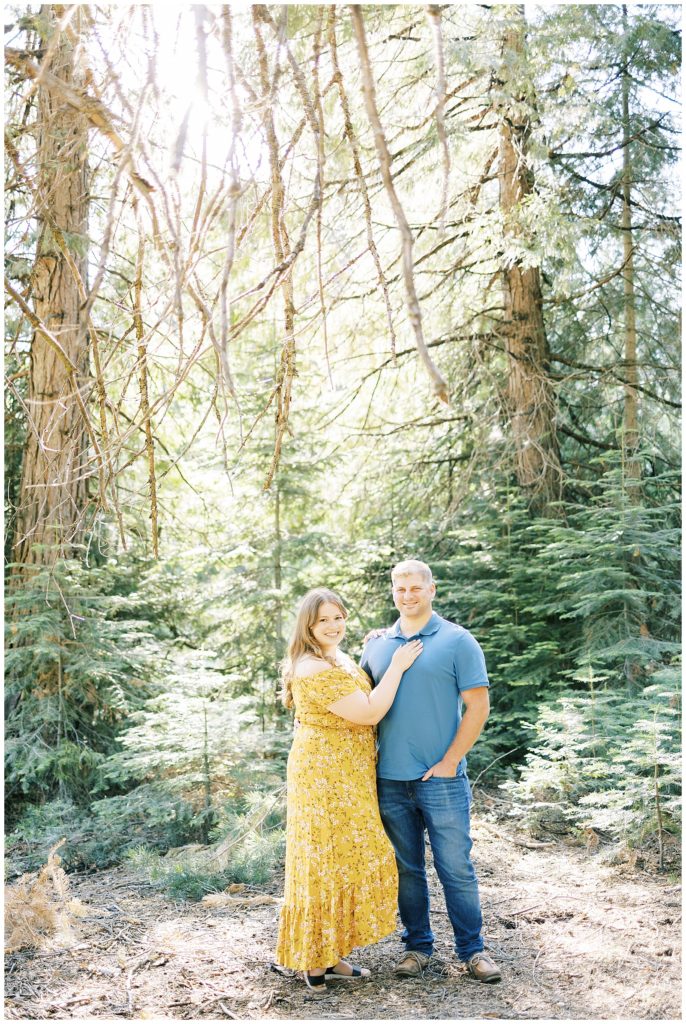 engaged couple wearing blue and yellow engagement photos shaver lake