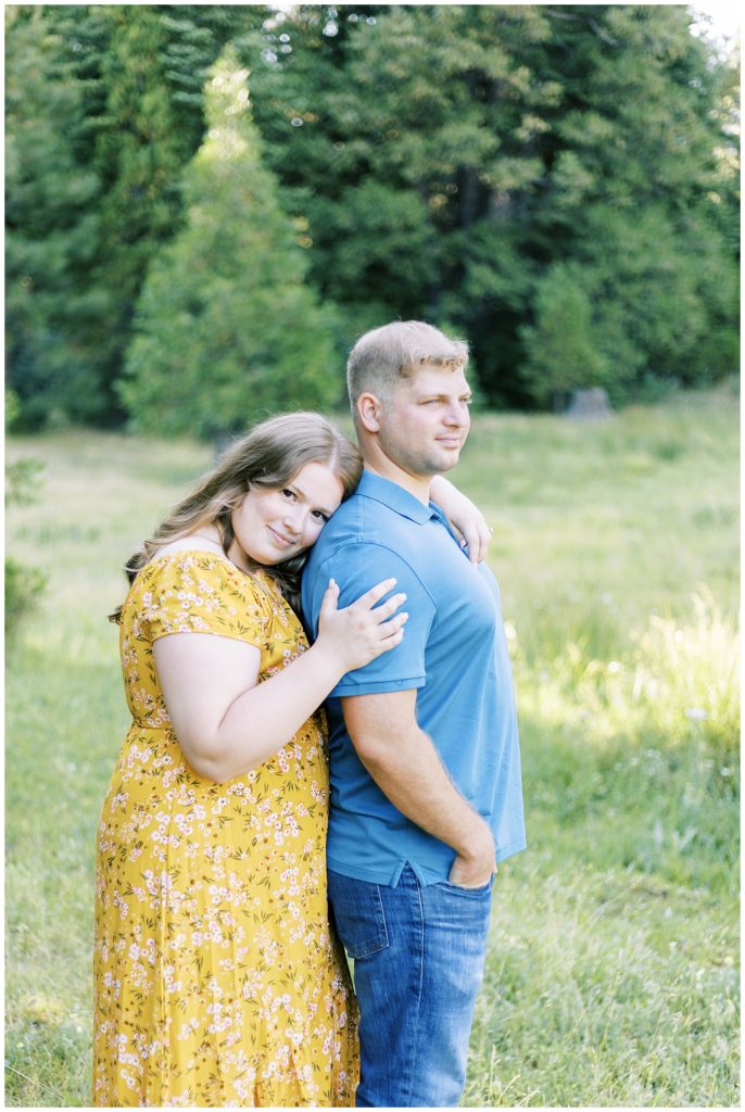 woman looking at camera while hugging fiance