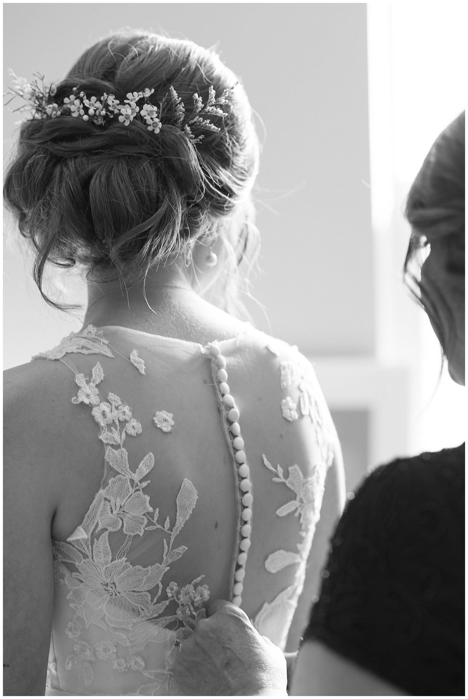black and white close up button back wedding dress bridal updo with flowers