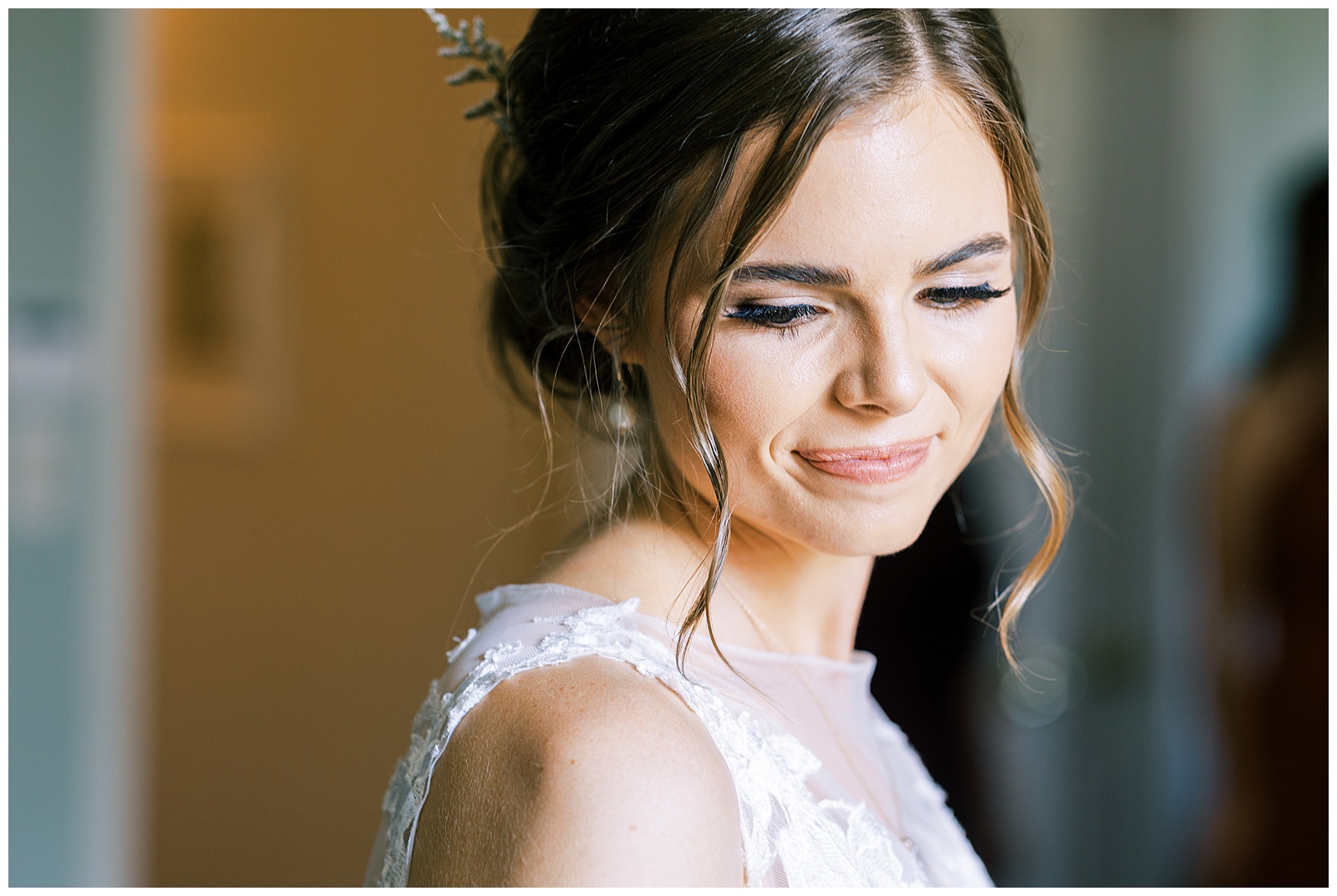close up image bride in lace wedding dress with soft curls updo