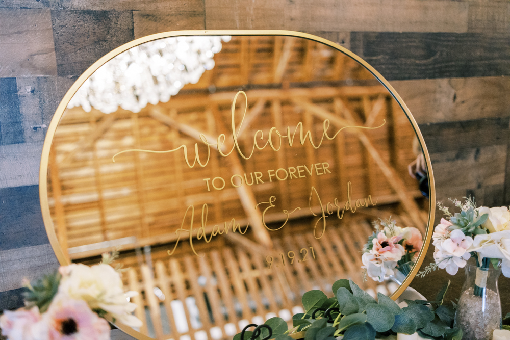 wedding welcome sign on gold mirror with gold calligraphy