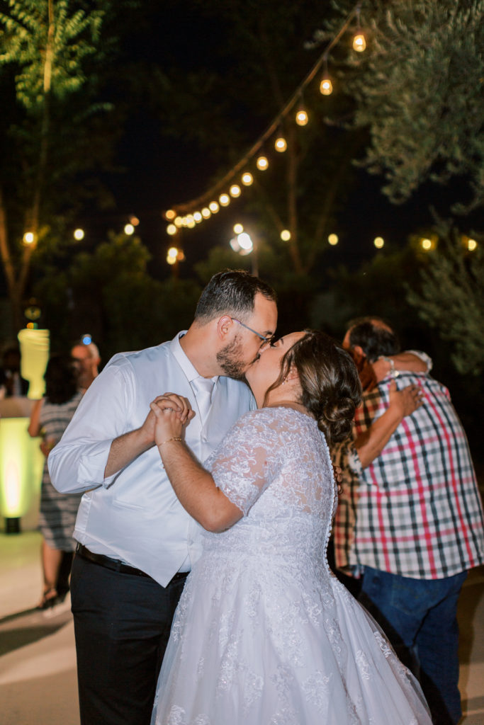 bride and groom kissing during reception dancing