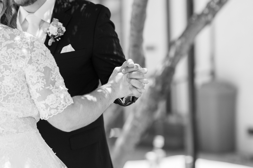 bride and groom holding hands black and white